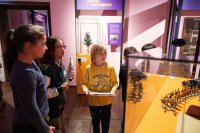 Kinder laufen durch die Ausstellung und halzen Rätselhefte in der Hand.