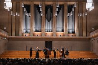 Musiker auf der Bühne im Hintergrund eine Orgel
