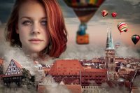 Der Kopf einer Frau schwebt über der Skyline von Nürnberg.