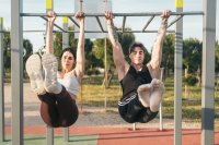 Ein Mann und eine Frau trainieren an einem Fitnessgerät