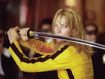 Copyright: 2003 MIRAMAX. ALL RIGHTS RESERVED
Eine Person in gelbem Kampfanzug hält entschlossen ein Katana-Schwert vor sich, das Gesicht mit einer Schnittwunde gezeichnet.