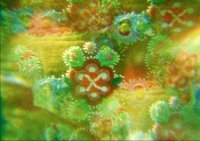 Abstrakte Nahaufnahme eines ornamentalen Musters mit blütenartigen Formen in Grün-, Gelb- und Rottönen.