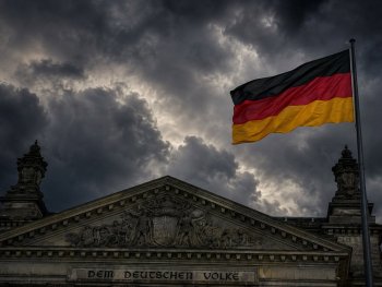Dunkle Wolken über dem Reichtstagsgebäude als Symbol für die Bedrohung der Demokratie durch den Wahlerfolg von Rechtextremisten