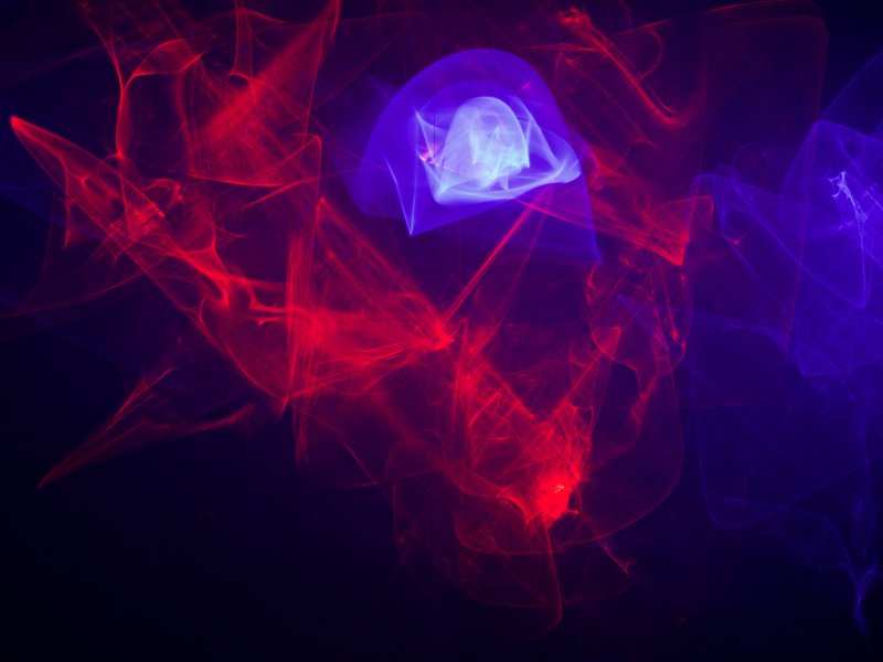 Light installation with red-blue light effects on a wall, people watch the projections on the wall.