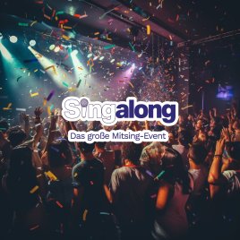 Menschenmenge bei einem Konzert mit buntem Konfetti und Bühnenbeleuchtung im Hintergrund
